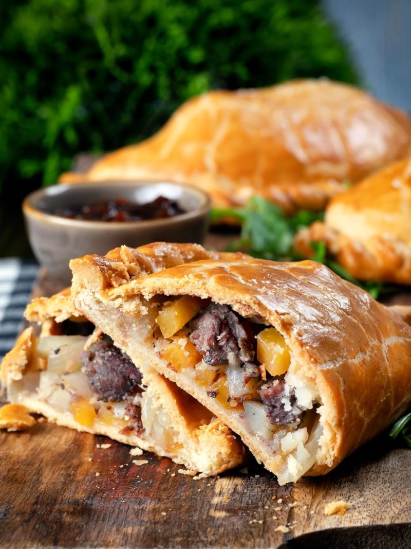 Sliced meat pasty showing steak, potato and seasoning